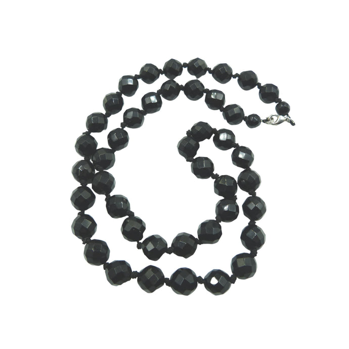 A lovely vintage Art Deco style hand strung necklace made of faceted black glass beads, which are similar in look to French Jet.