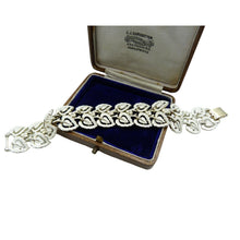 Load image into Gallery viewer, A beautiful 1950s vintage Jewelcraft bracelet made of silver tone white metal decorated with a white enamel leaf pattern design and a gold coloured clasp. 